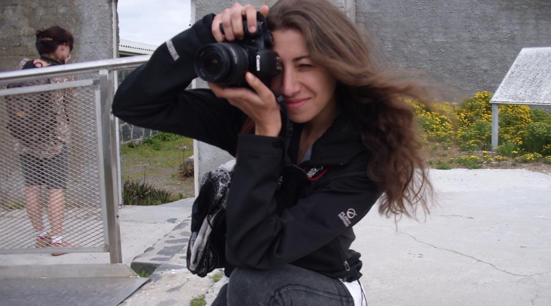 A Projects Abroad journalism intern takes a picture at her placement in South Africa A journalism intern in South Africa collecting photographs for a story